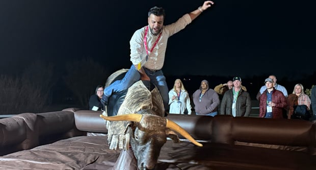 The mechanical bull at Circle R Ranch proved a worthy challenge for attendees of the off-site social event. (Photo: WorkWave)